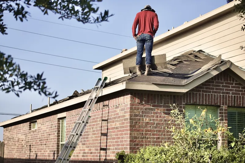 Professional roofer working on a residential roof in Powdersville